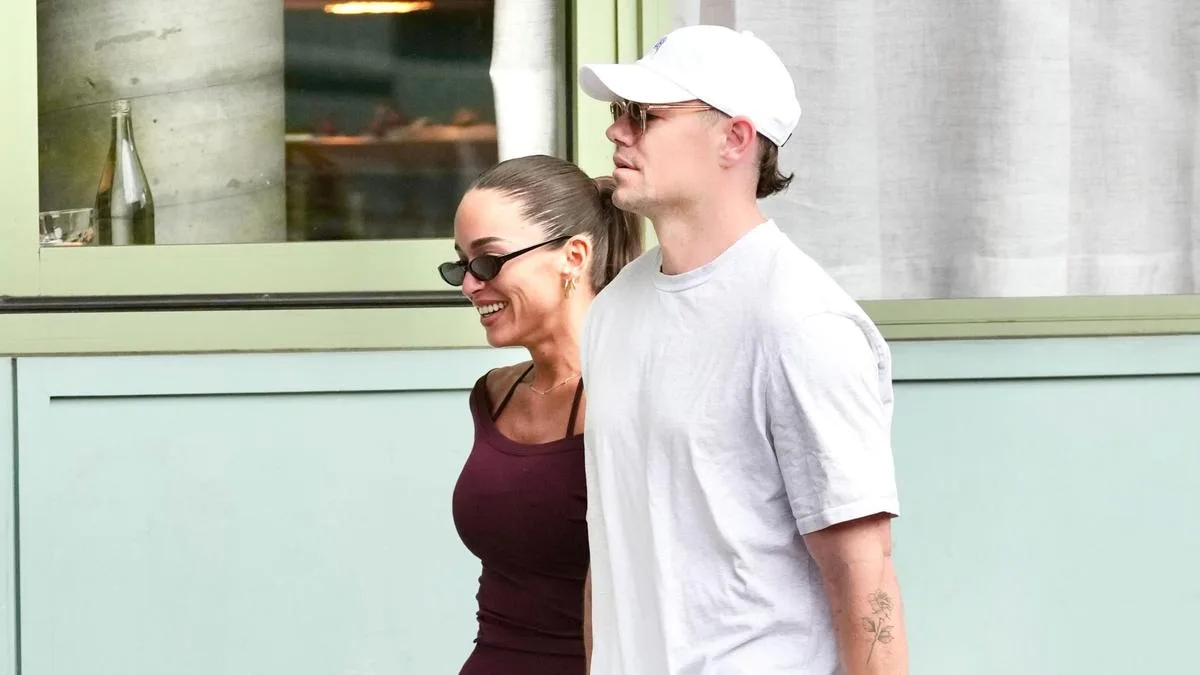Lachie Neale loved up with girlfriend Emma Field as he awaits final decision on the appeal of his suspension