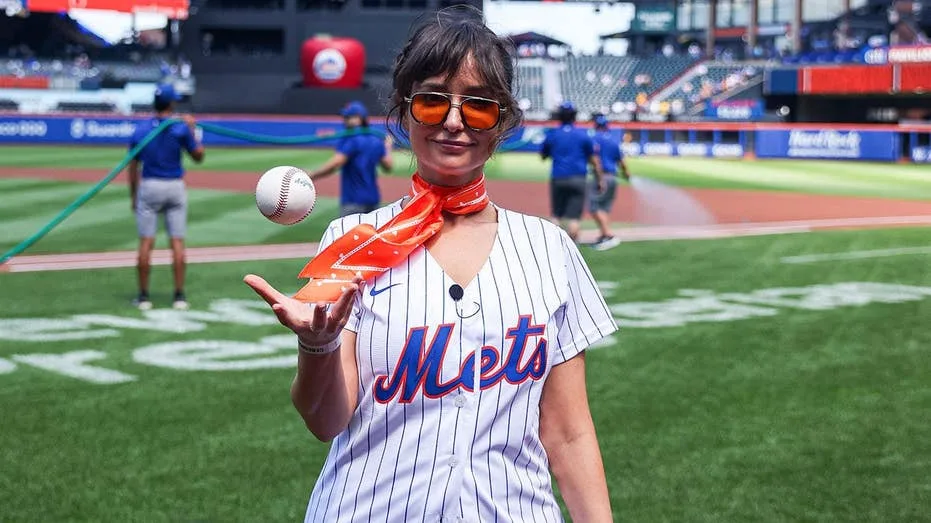 AT&T star Milana Vayntrub shows off her arm during first pitch at Mets game, WNBA flying object & LLWS grass