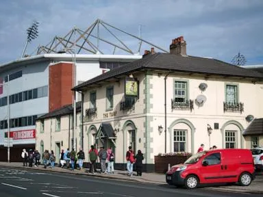 Cheers! Wrexham's celebrity owners buy 'The Turf' pub that's adjacent to the club's stadium
