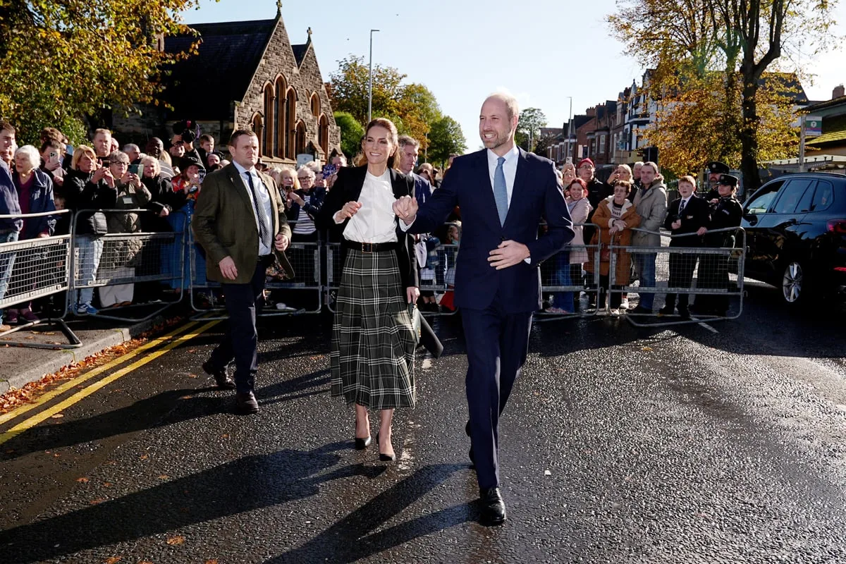 William and Kate dodge rain showers to meet community centre supporters