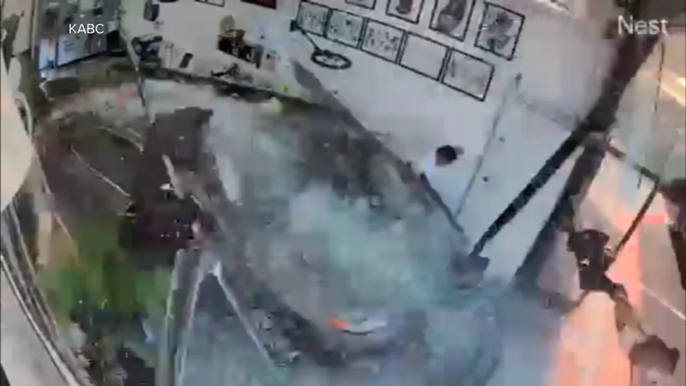WATCH: Car slams into tattoo shop