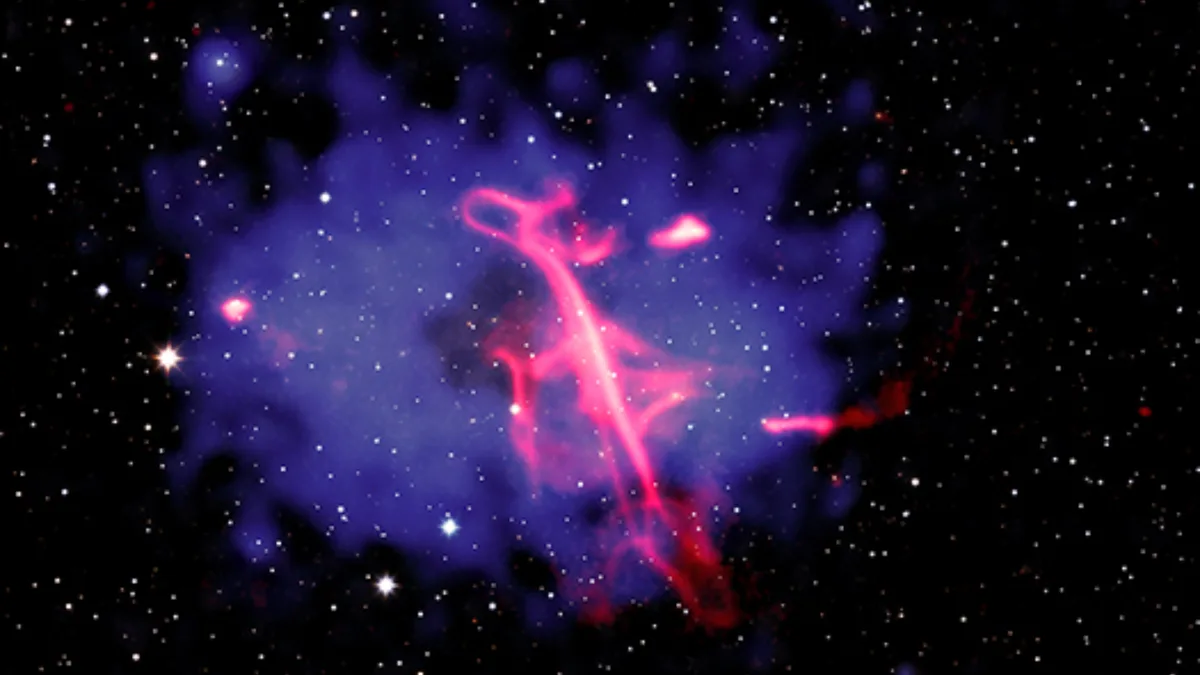 Supermassive black hole blasts out a neon 'treble clef' | Space photo of the day for Oct. 16, 2026