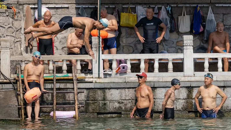 In the shadow of a palace, Beijing’s uncles defy a swimming ban to cool off