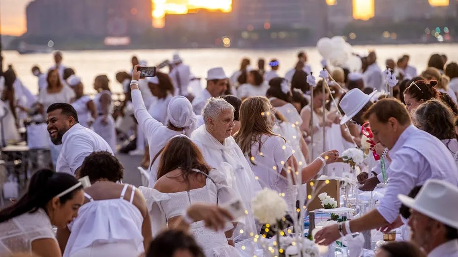 Dinner party has guests bringing tables, dressing in white and learning location last-minute