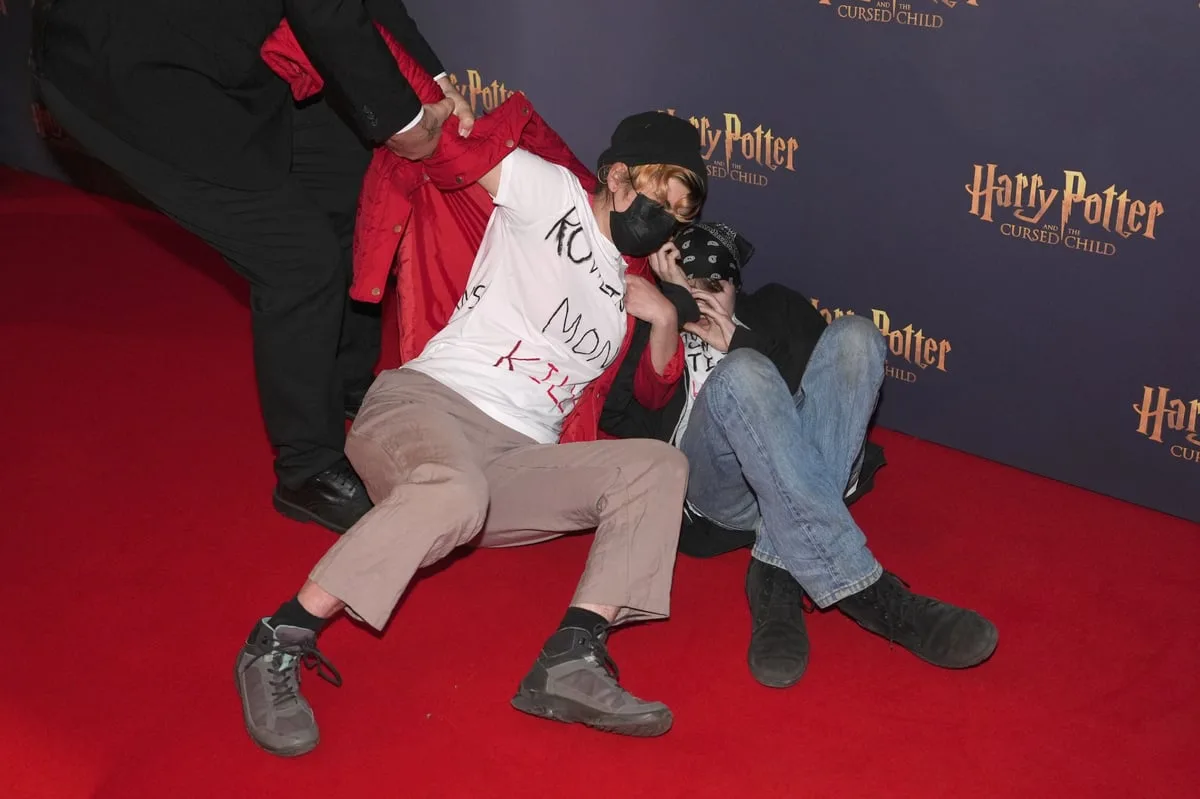 Trans rights activists rush carpet before Harry Potter And The Cursed Child show