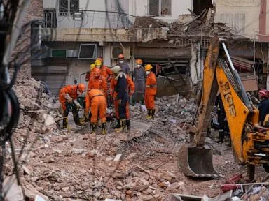 Rescuers search for people trapped in New Delhi building collapse as death toll rises