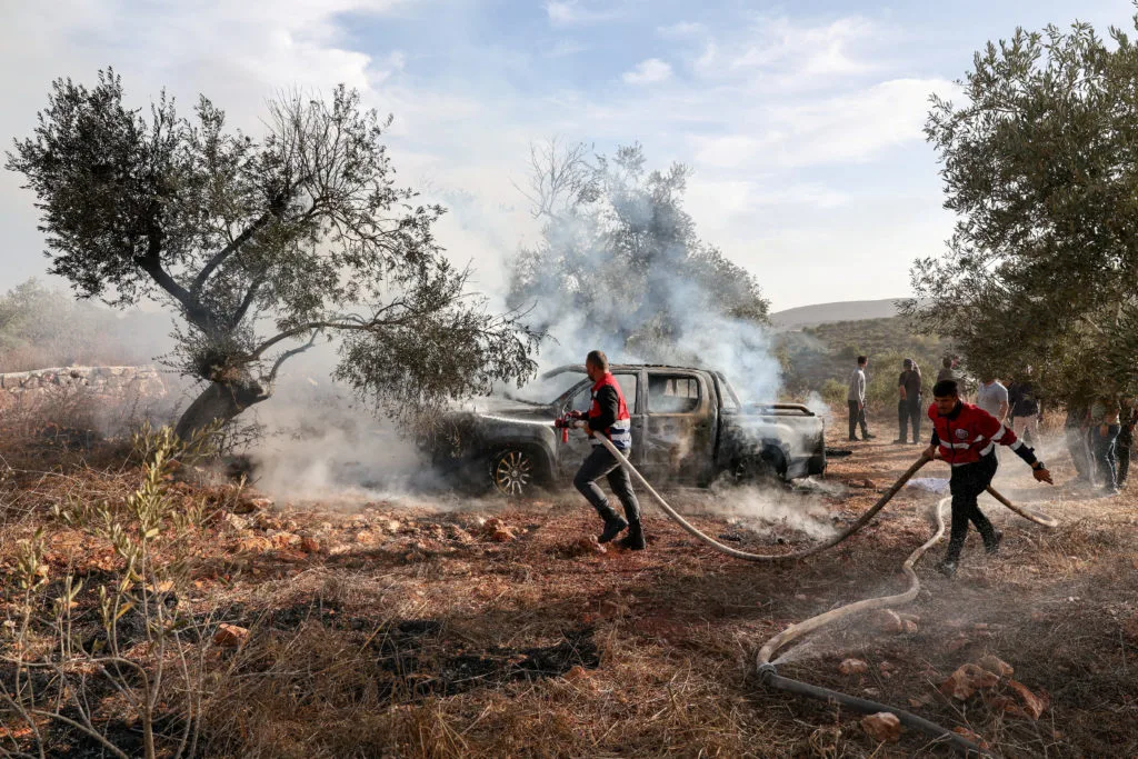 Israeli settlers attack Palestinians during West Bank olive harvest and beat U.S. photojournalist