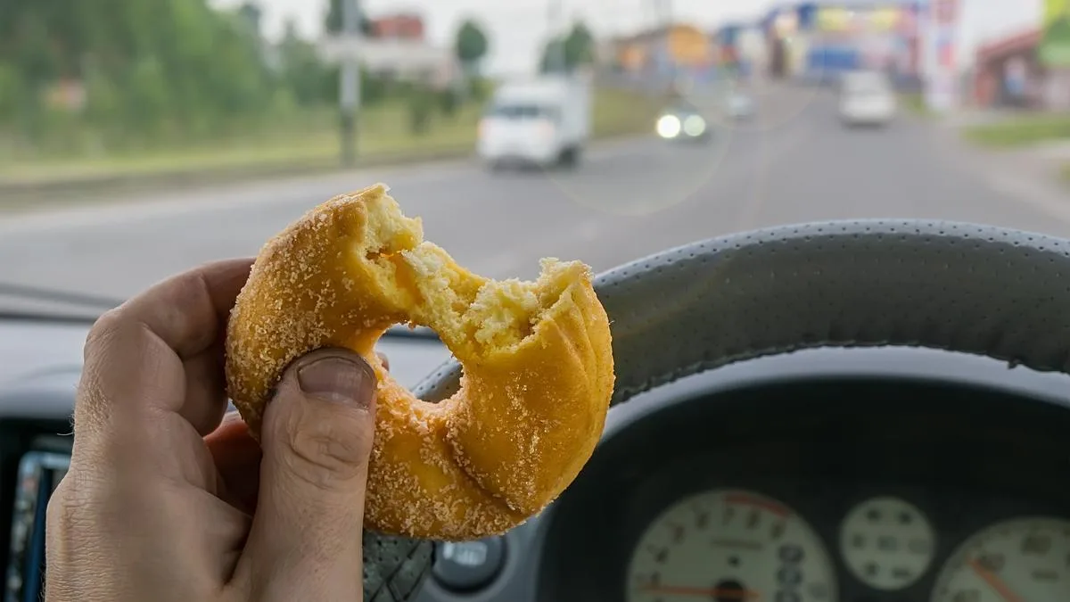 No, it's not legal to butter a bagel while driving
