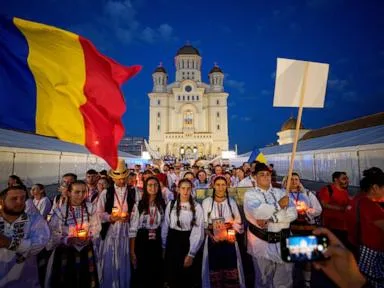 Young Orthodox Christians take part in a lights procession in Romania’s capital