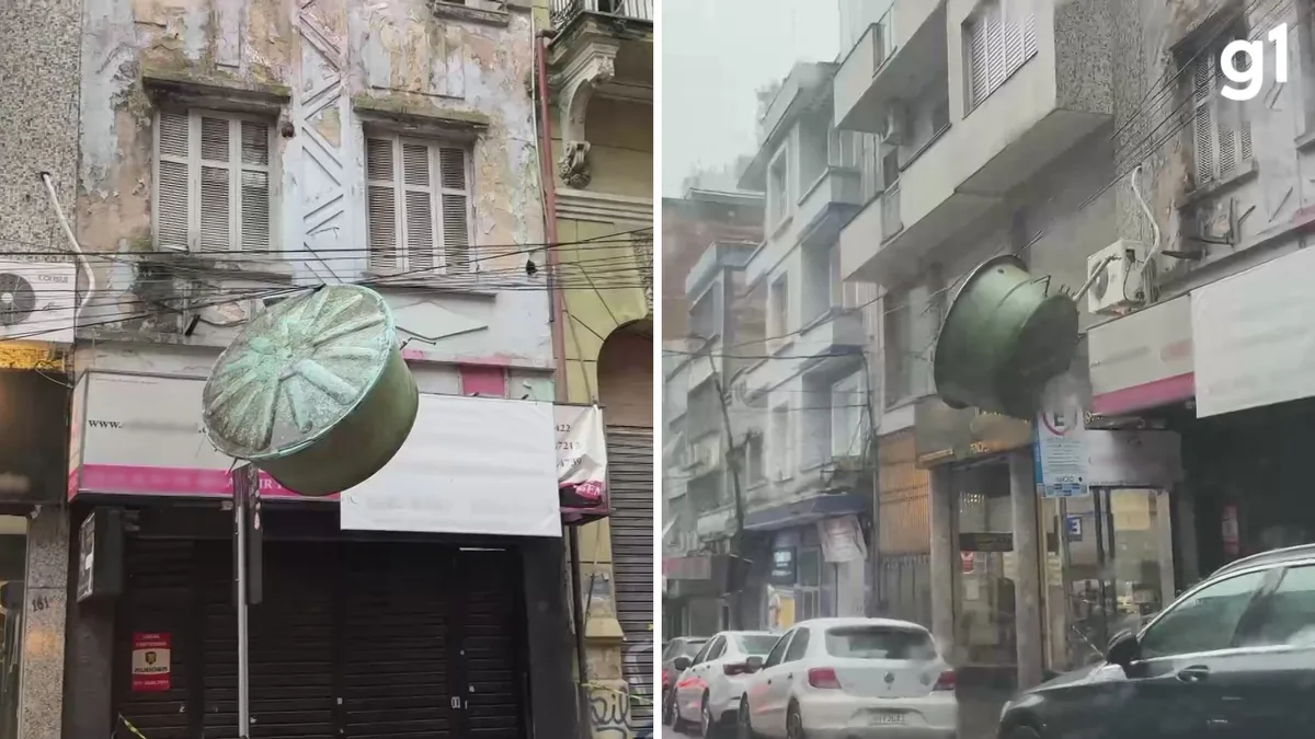 VÍDEO: Caixa d'água despenca de prédio abandonado e fica suspensa em fios no Centro de Porto Alegre após ventania