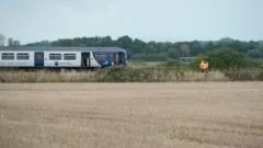 Man dies after train hits van on level crossing