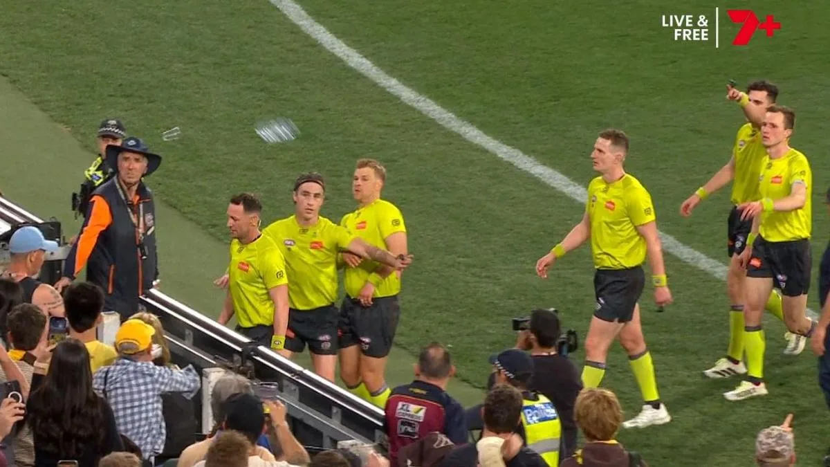 Ugly scenes as angry Hawthorn fans hurl bottes at umpires after preliminary final loss to Brisbane