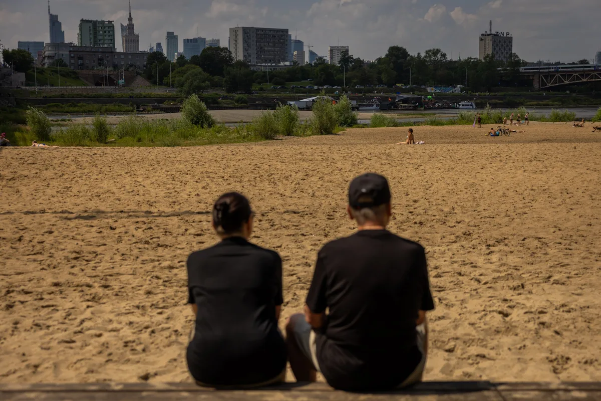 Along a Vistula River withered by extreme heat, Poles keep cool and carry on
