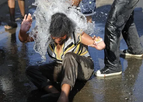 Gauteng cops warn pouring water on someone is a criminal offence, urges victims to open cases