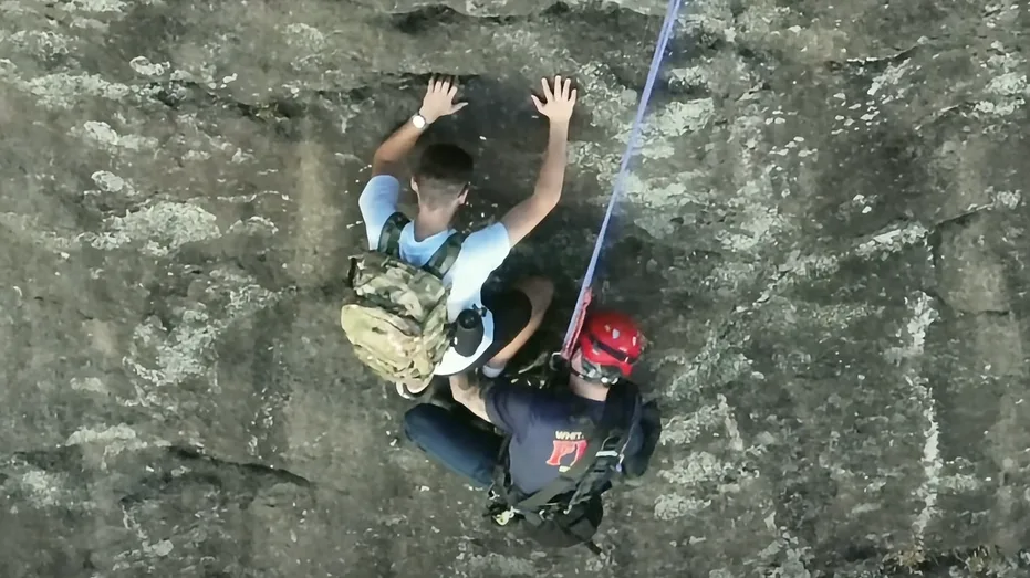 Free climber stranded on Georgia rock face calls 911, prompting dramatic rescue by firefighter