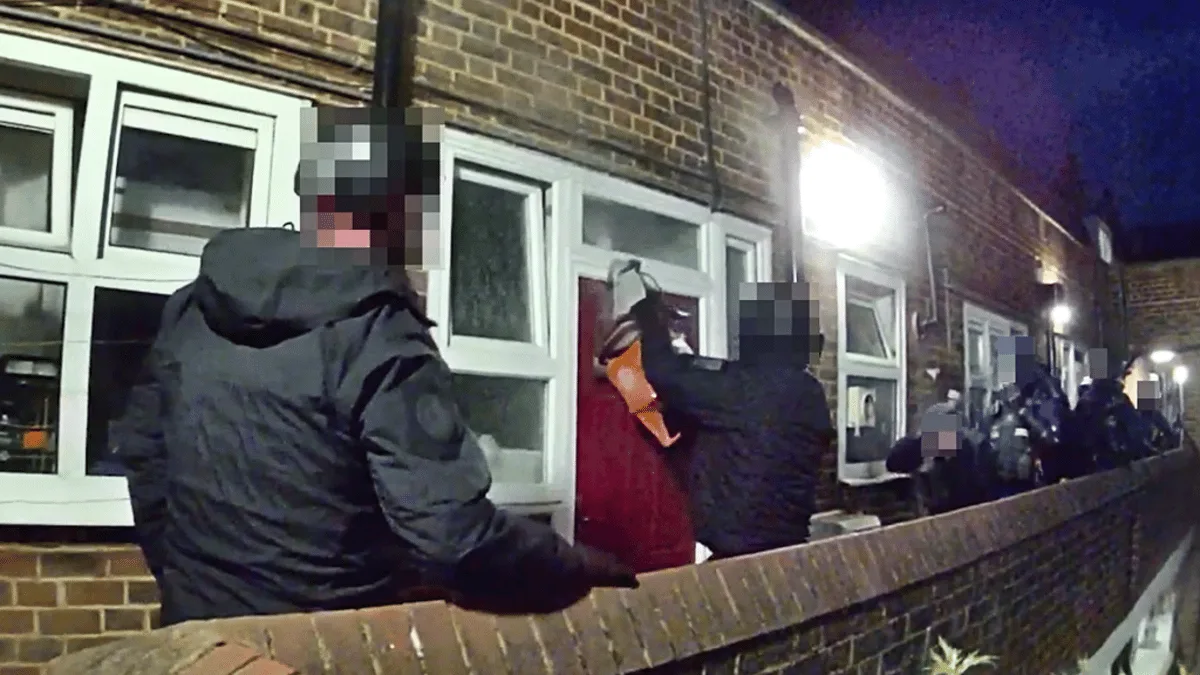 Dramatic moment police slice open front door with electric saw in dawn raid on suspected knife smuggler's London home