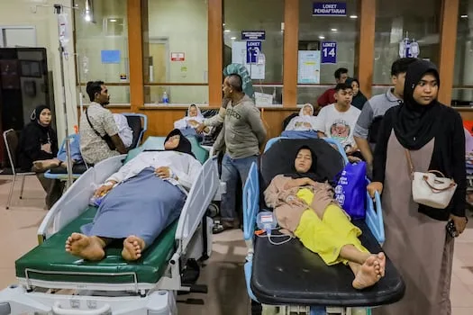 Indonesian officials suspect food poisoning from free school meals after more than 500 fall ill