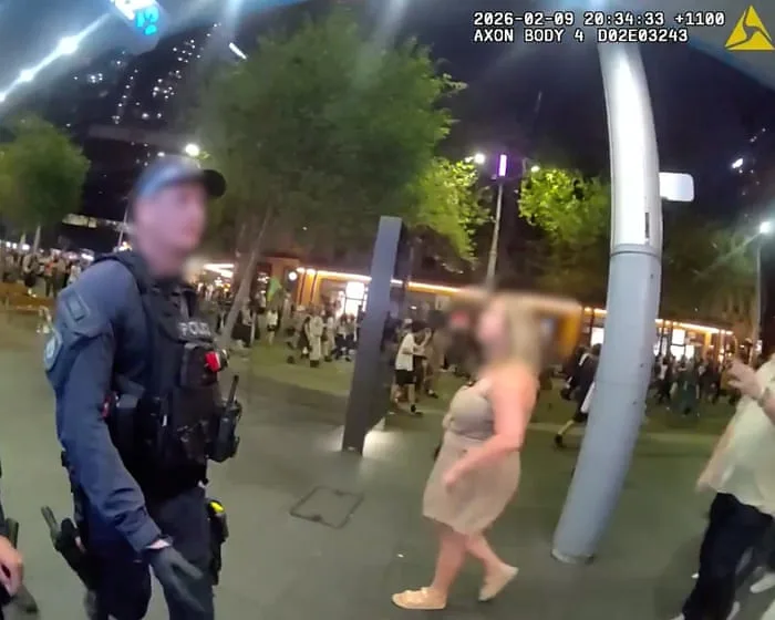 Footage shows NSW police officer boasting about 'punching' anti-Herzog protester in head – video