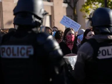 Police fire tear gas at a barricaded Paris school as protests show no sign of ending