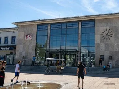A British woman is fatally stabbed at a station in Germany. Police detain a suspect