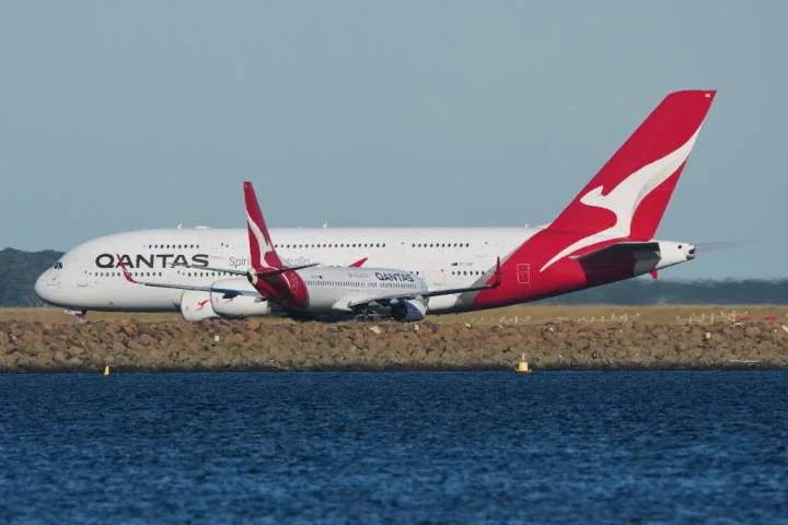 Man charged after allegedly trying to open Qantas plane door mid-flight