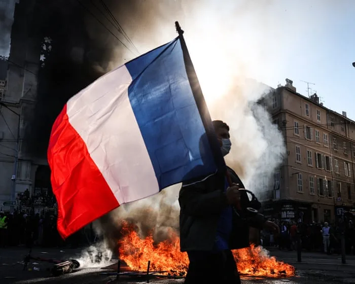Macron refuses minister’s resignation after huge protests rock France – Europe live