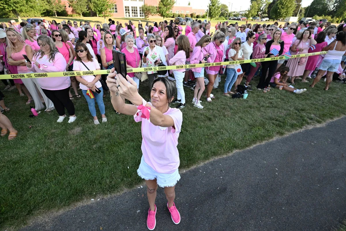 Women in pink rally in support of Lindsay Clancy who is on trial for killing 3 children