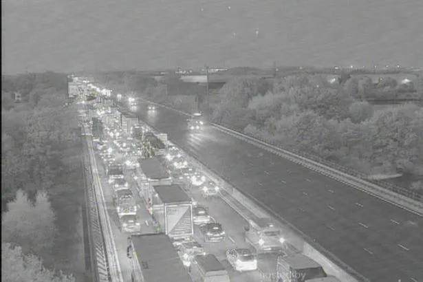 M1 Nottingham live: Standstill traffic as lorry overturns and 'crashes into central barrier'