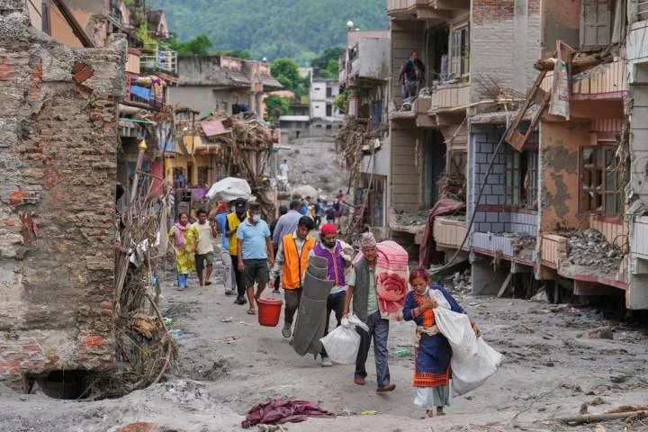 Nepal flood survivors reach safe areas as families await news of missing