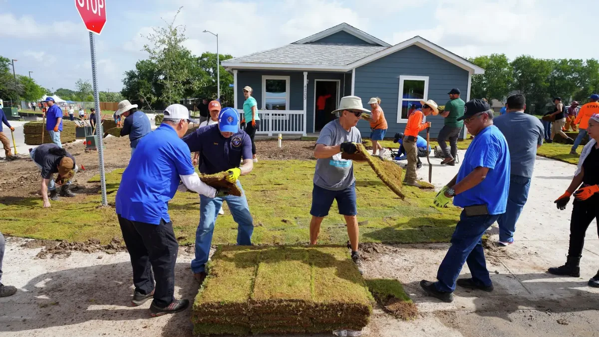 More than 1,000 volunteers built a four-bedroom house in 50 hours, launching 35-home community