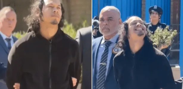 Acusado de jogar namorada e filha de varanda sorri ao ser preso nos EUA
