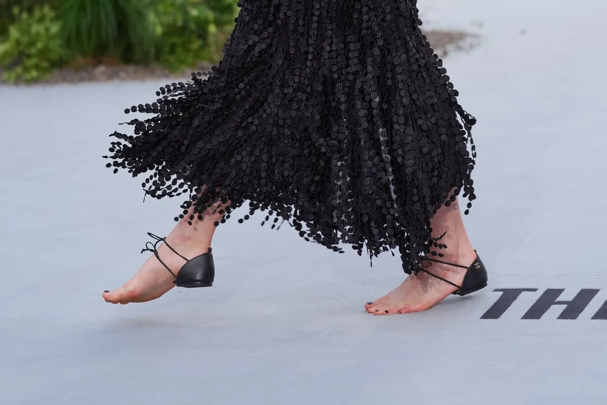 Margaret Qualley walks white carpet in barefoot Chanel sandals