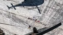 Watch: Helicopter hovers feet from cliff face during rescue