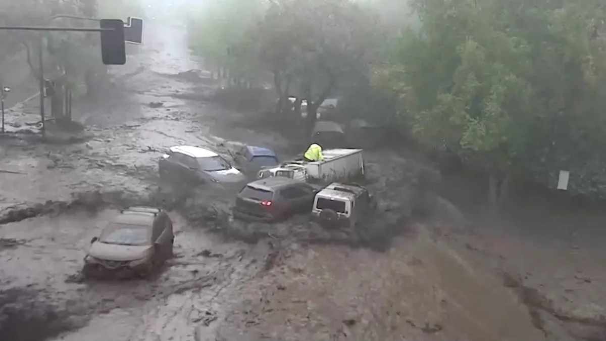Video: Cars swept into a pile as muddy floodwater rushes down Chile street