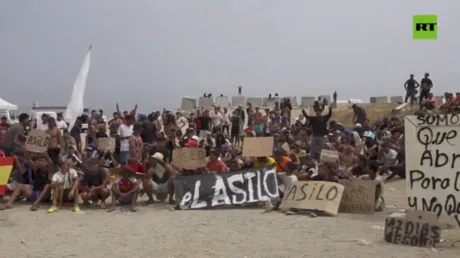 WATCH hundreds of migrants demand asylum in Spanish enclave