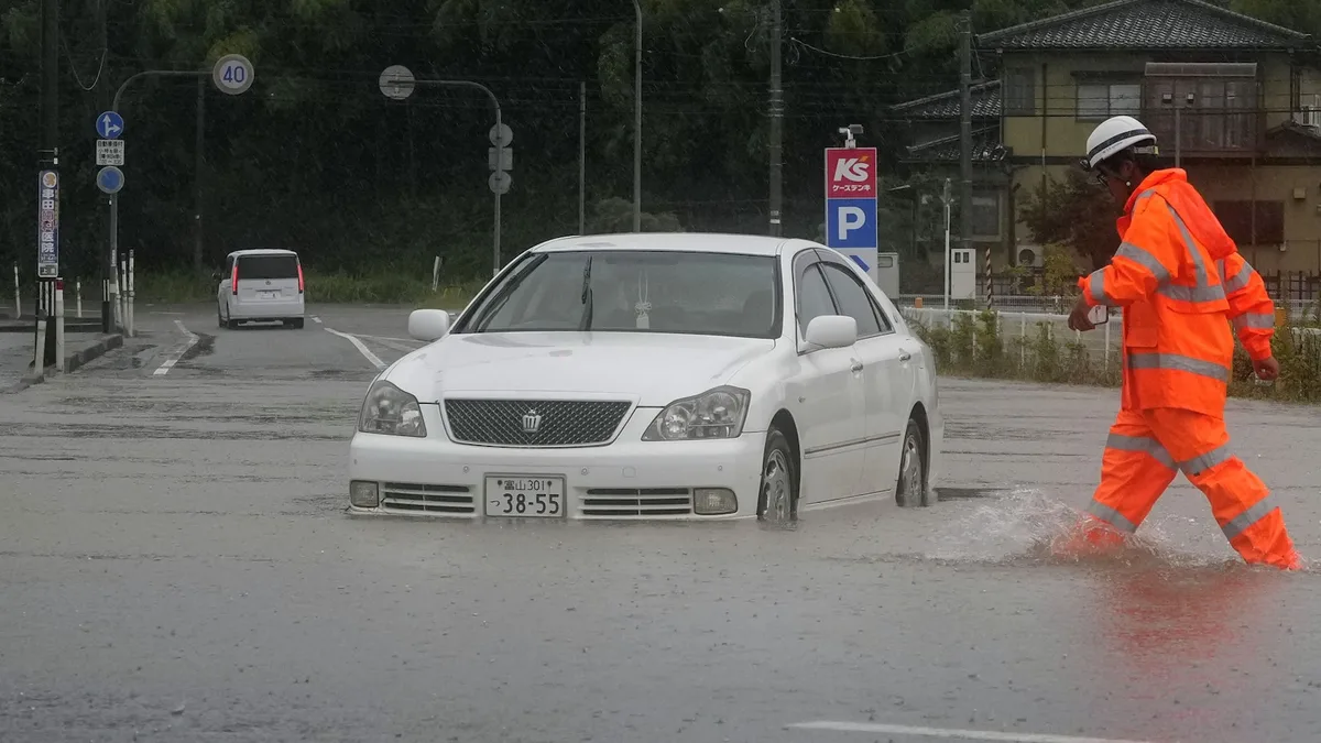 Heavy rain and flooding in north-central Japan strands people and vehicles