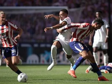 Atletico Madrid beats 10-man Real Madrid 2-1 in derby, Man City outlasts Sunderland in England