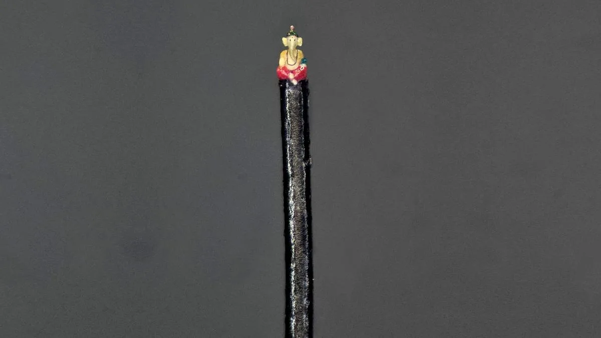 Tiniest Ganesha sculpted on a human hair strand