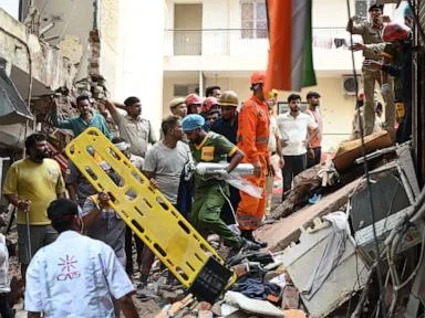 Building collapse in New Delhi kills 1 and traps dozens of others