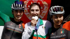 Cyclist who dressed as man to avoid Taliban wins silver medal