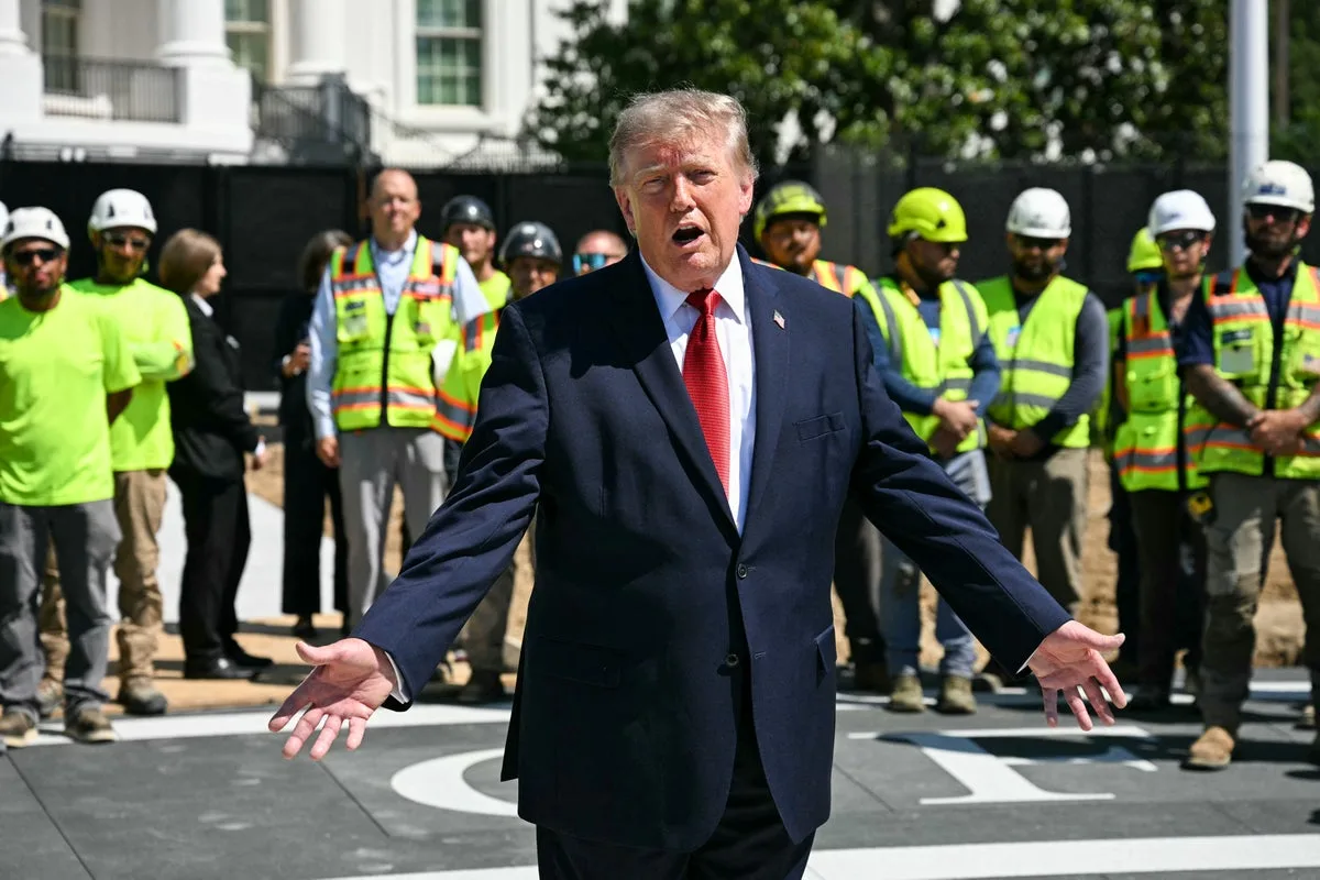 Trump unveils latest construction obsession with hardhat tour of White House helipad: ‘Real artists’