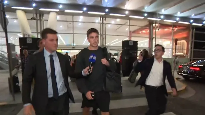 Swans player swarmed at airport