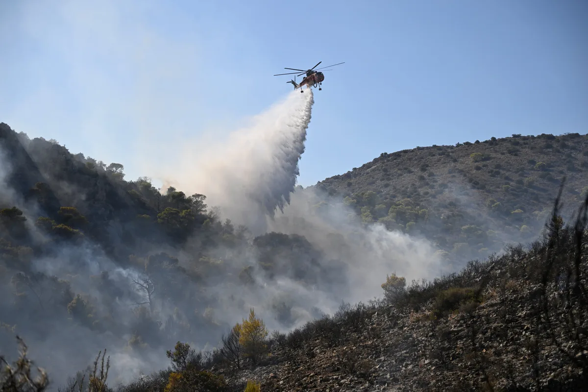 Crews battle major wildfires in Belgium and Greece as two die on island near Athens