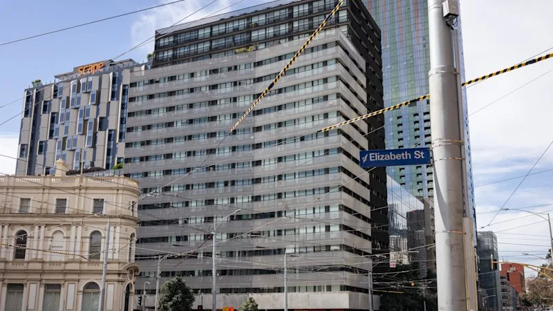 Warring strata companies leave Carlton apartment block with slow lifts, disgusting carpets, cracked windows