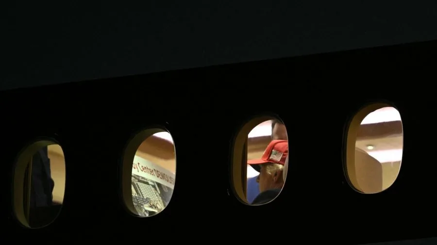Trump appears to review poster about Kennedy Center demolition on Air Force One