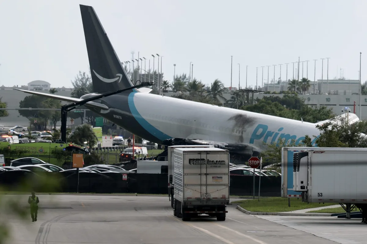At least 5 dead after Amazon cargo plane barrels off runway at Miami airport, crashes into vehicles and bursts into flames