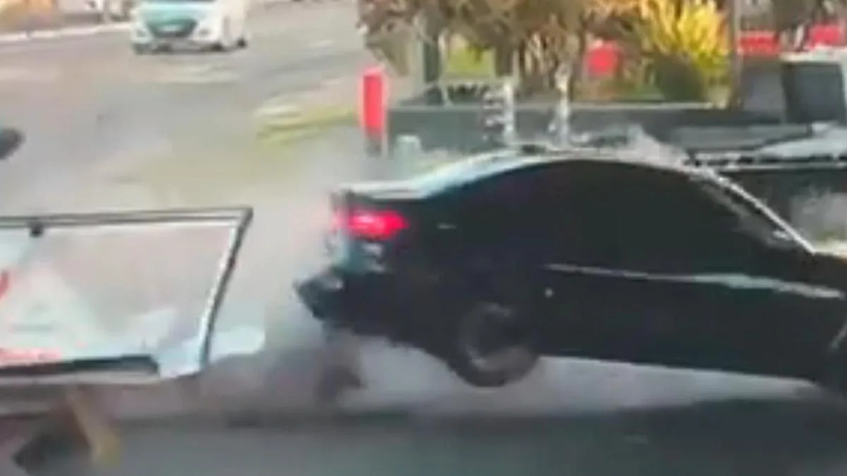 Wild moment car smashes through Sydney petrol station, narrowly misses pedestrian