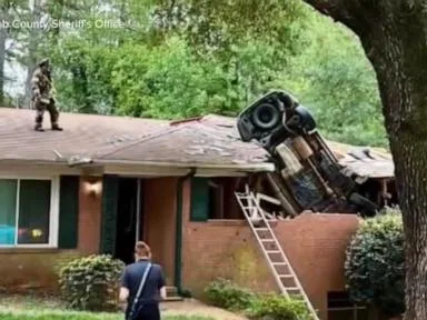 WATCH: Car lands on Georgia home in deadly crash