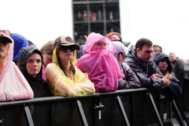 Reading Festival fans brave torrential rain and mud bogs as Britain faces horror thunderstorms this weekend