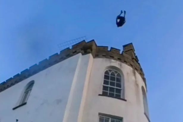 Reckless thrillseekers ignore police warnings to plunge into sea from children’s charity roof
